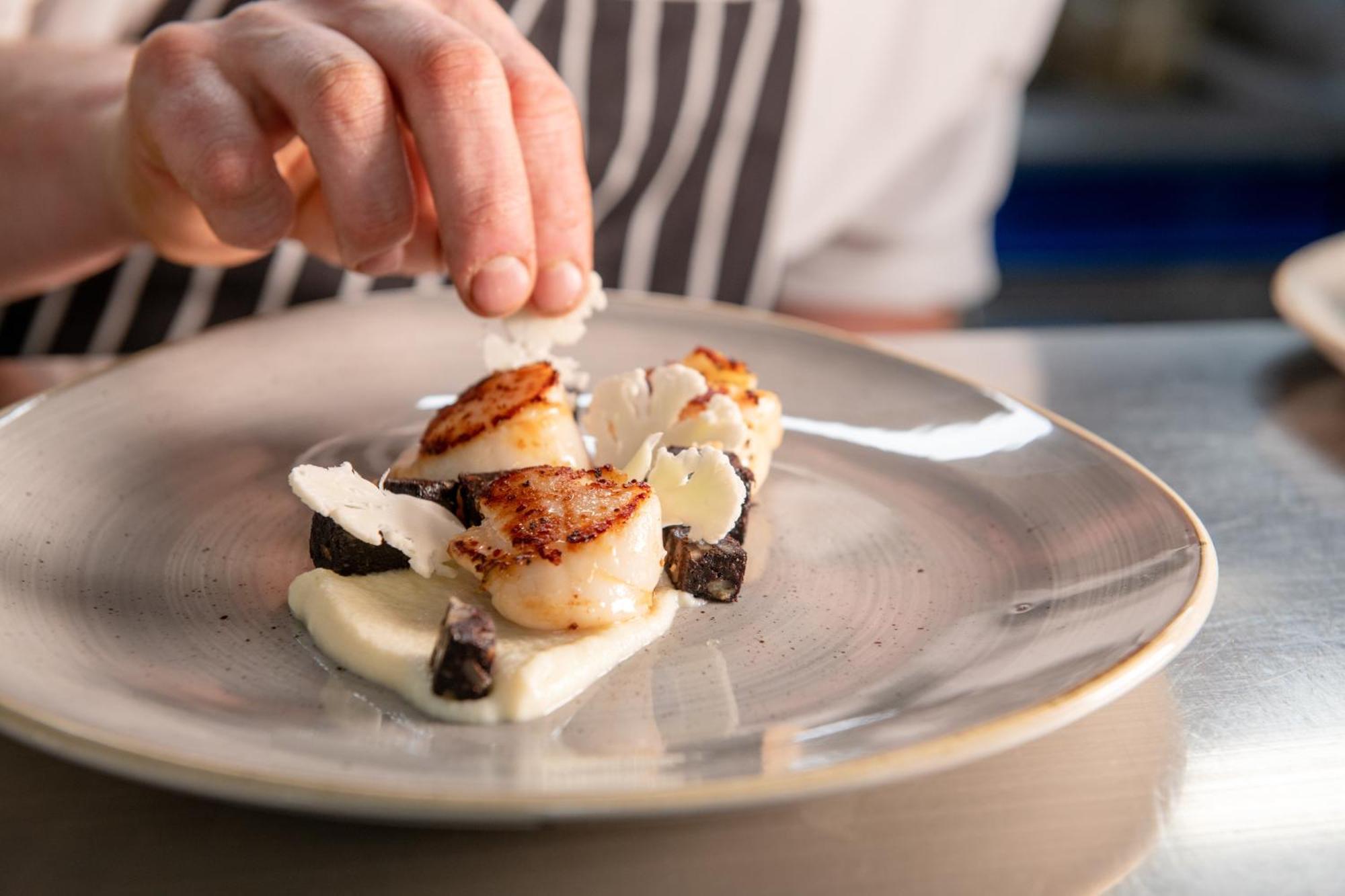 The Millstone, Mellor Hotell Blackburn  Exteriör bild A chef finishing a plate of scallops